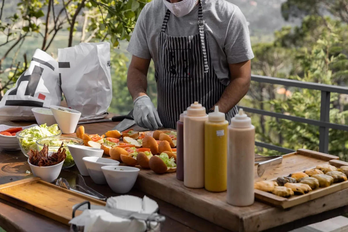 A Husk chef at a live outdoor catering station